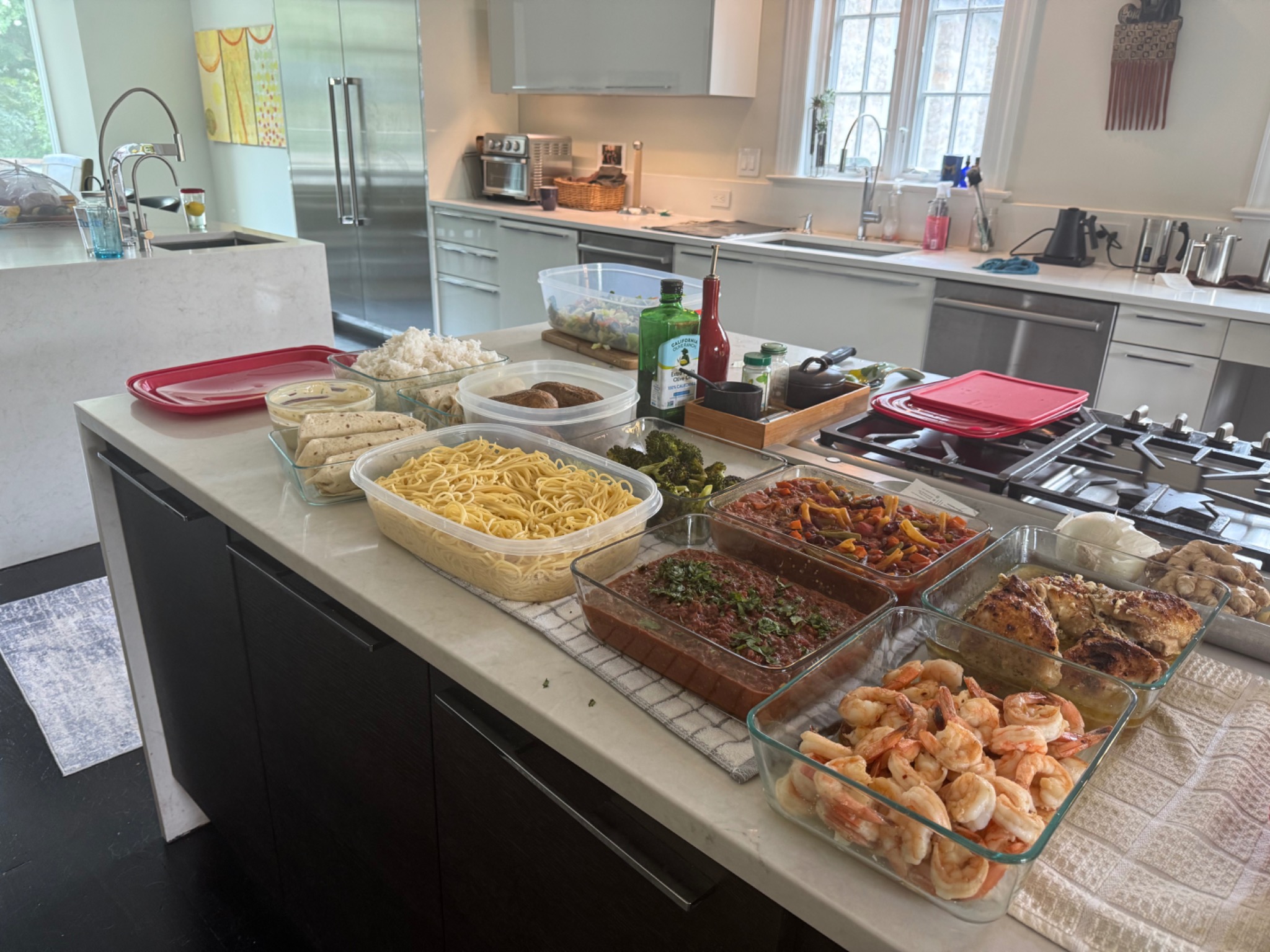 An in-home personal chef cook day with an assortment of prepared foods on a kitchen island