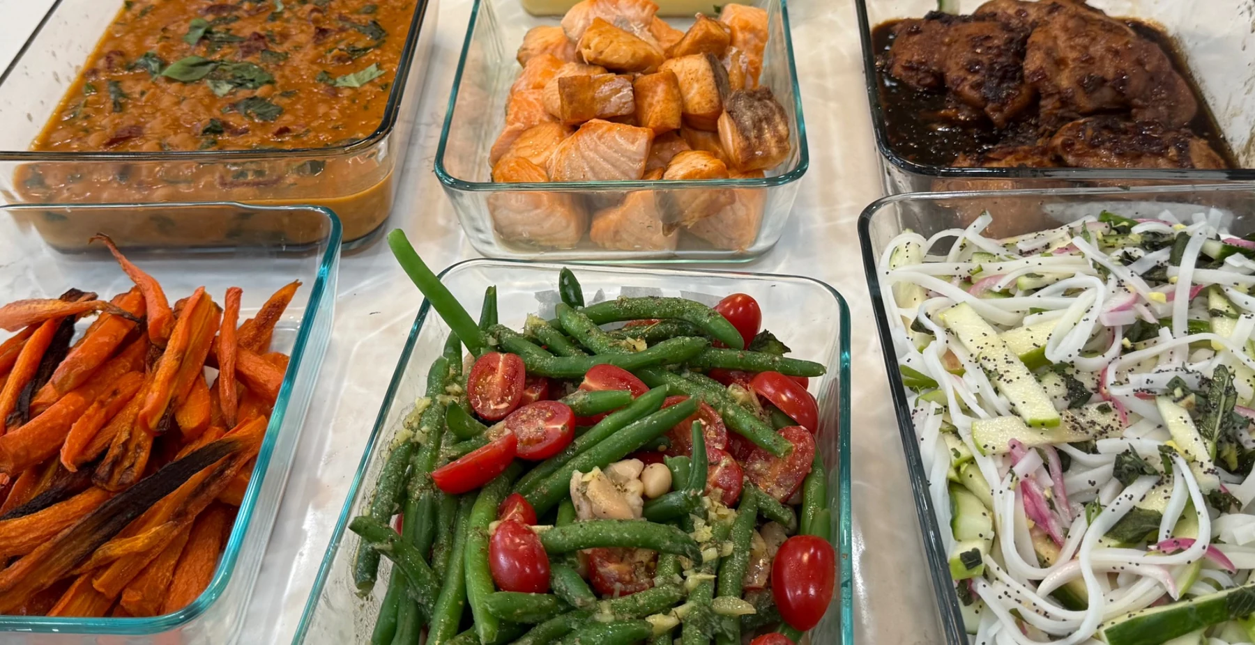 Colorful prepared meal prep foods in glass containers